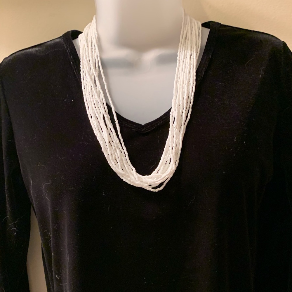 White multi strand beaded necklace. White. 26”